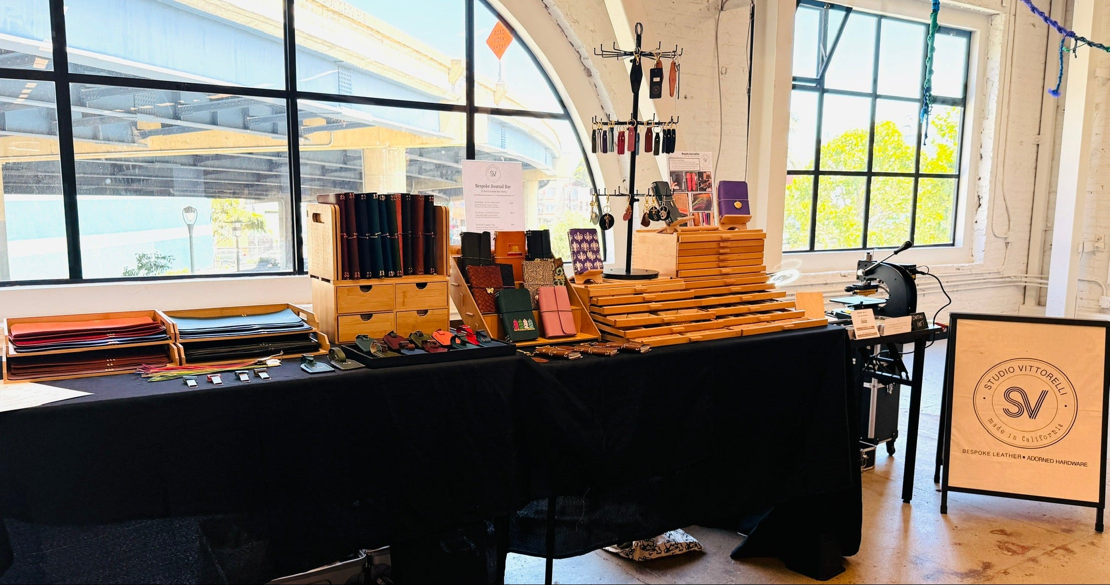 Display of bindery materials on a table with large windows in the background