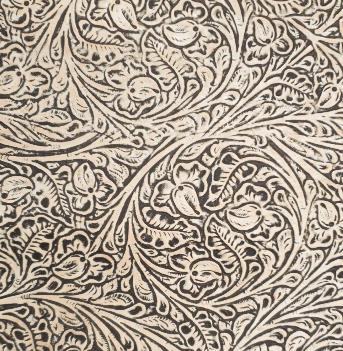 Decorative embossed flower pattern with intricate designs on a beige stamped leather