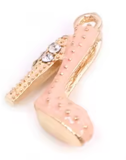 Gold and pink shoe charm on a white background