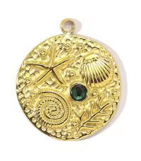 Gold charm with beach sand designs and a central rhinestone on a white background