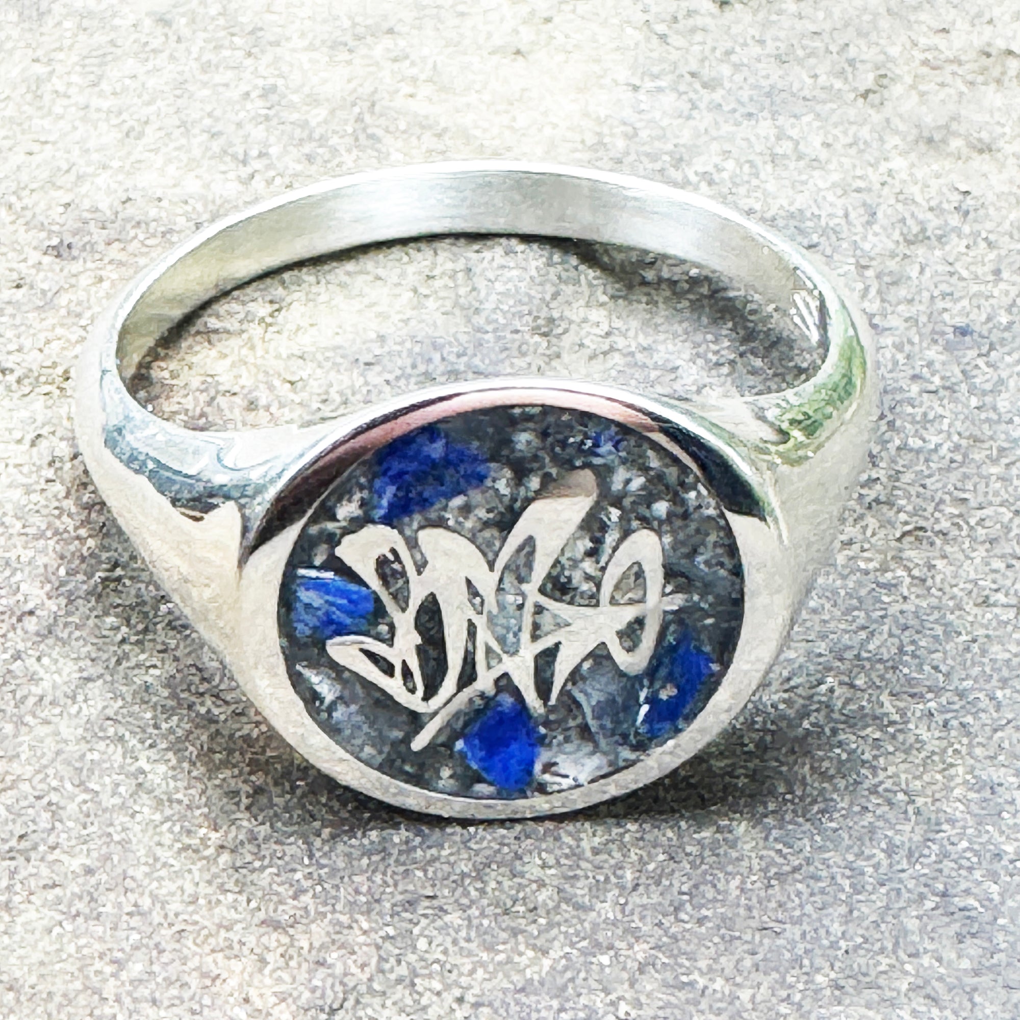 Finished custom memorial ring with logo design, ash and crushed lapis