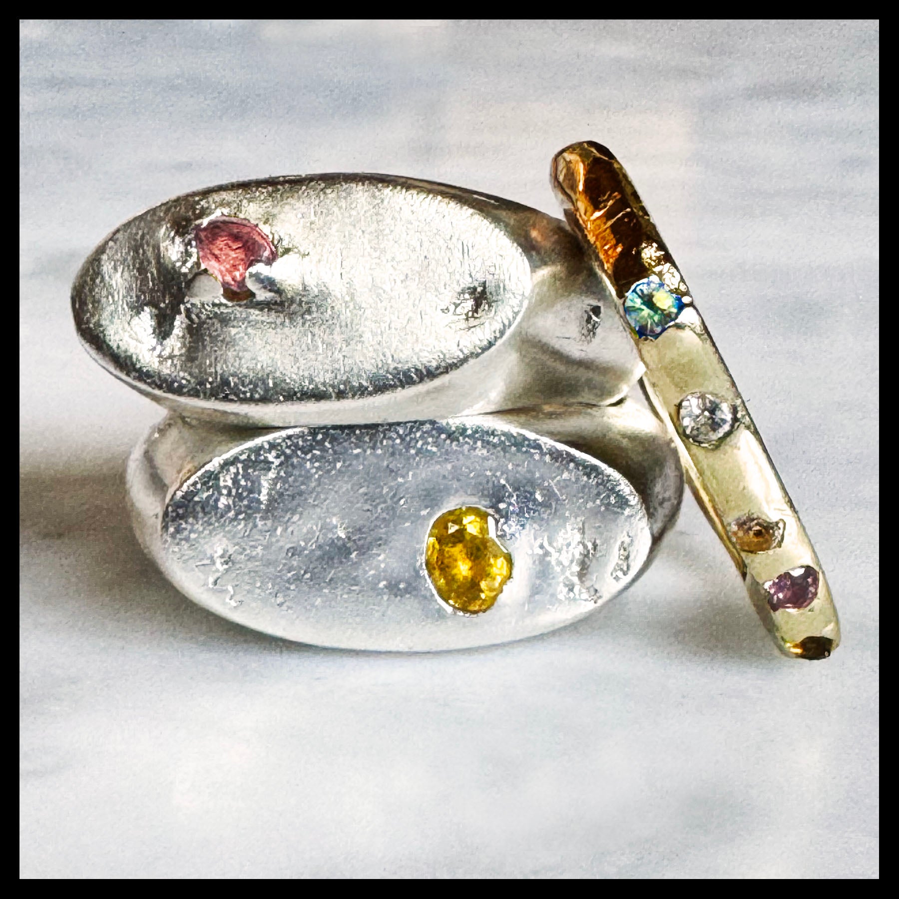 stack of rings with gemstones