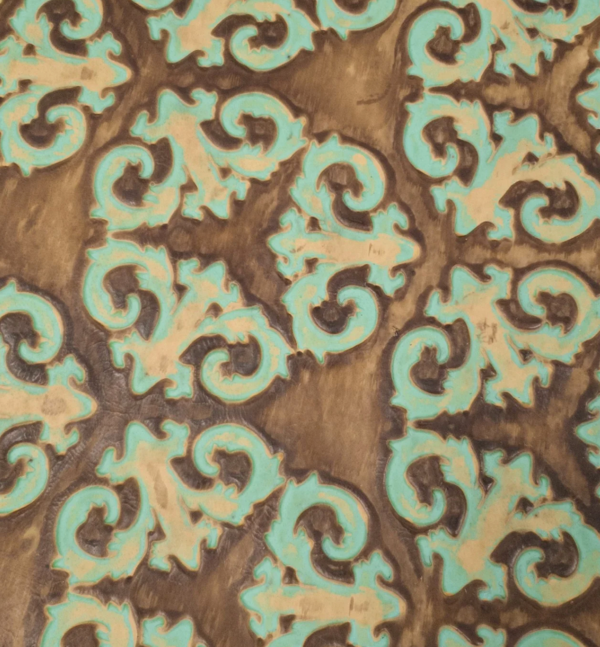 Decorative pattern with turquoise and brown colors on leather